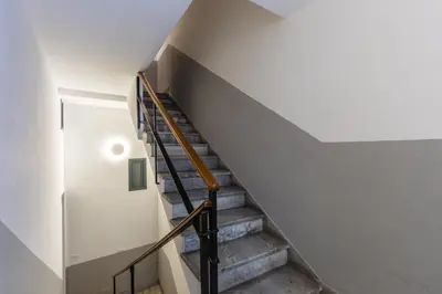 a staircase in a house with a white wall at Loft Piazza Marina Family by DomuSicily in Palermo