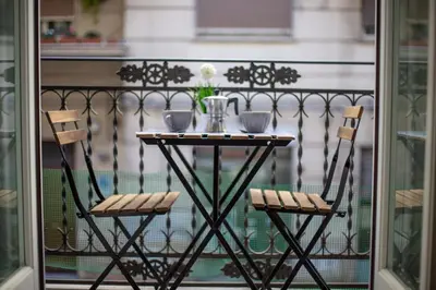 a table and two chairs on a balcony at Loft Piazza Marina Family by DomuSicily in Palermo