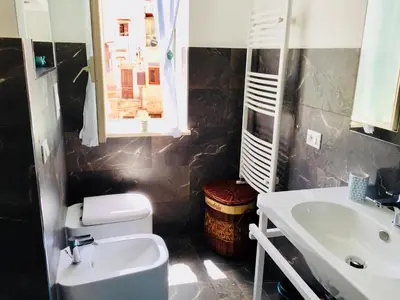 a bathroom with a sink and a toilet at Gò Gò House in Palermo