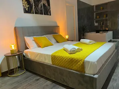 a bedroom with a large bed with towels on it at FUDDIA Room & Suite in Palermo