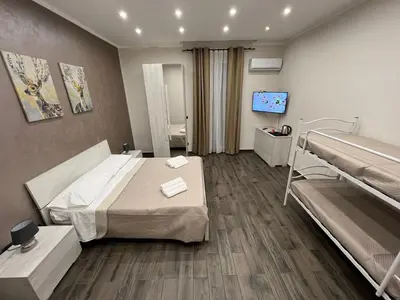 a hospital room with two beds and a television at FUDDIA Room & Suite in Palermo