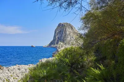 a view of the ocean with a mountain in the distance at Villa Majus in Porticello