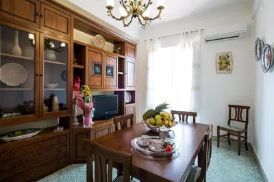 a dining room with a table with a bowl of fruit on it at Mille e una Notte / Station Apartment in Palermo