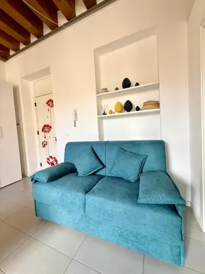 a blue couch in a living room at Capo Loft in Palermo