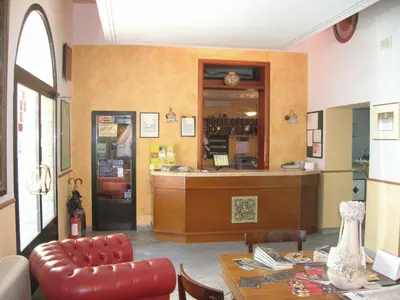 a restaurant with a counter and a table with a chair at Hotel Villa Archirafi in Palermo