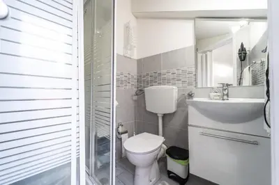 a bathroom with a toilet and a sink and a mirror at Casa di Cecilia in Castellammare del Golfo