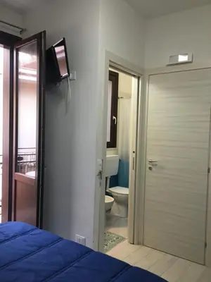 a bedroom with a door to a bathroom with a toilet at Casa di Cecilia in Castellammare del Golfo