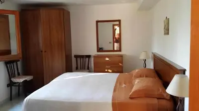 a bedroom with a bed and a dresser and a mirror at Casa Rosalba in San Vito lo Capo