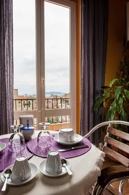 a table with a purple table cloth and a window at Sky Sleeping in Palermo