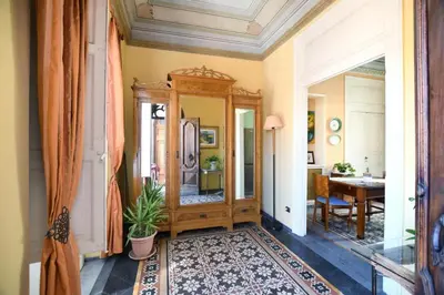 a hallway with a mirror and a dining room at Al Massimo Piacere in Palermo