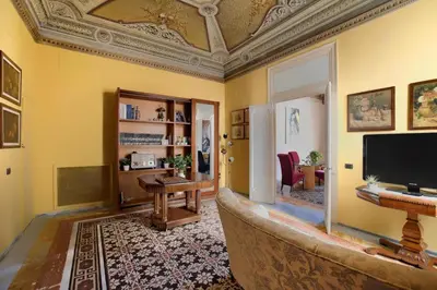 a living room with a couch and a flat screen tv at Al Massimo Piacere in Palermo