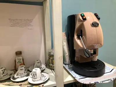 a coffee maker sitting on top of a shelf at La Bella Balla-rò Rooms in Palermo