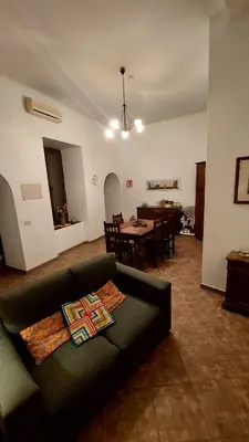 a living room with a couch and a dining room at David house alla Vucciria in Palermo