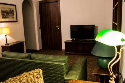 a living room with a green couch and a green lamp at David house alla Vucciria in Palermo