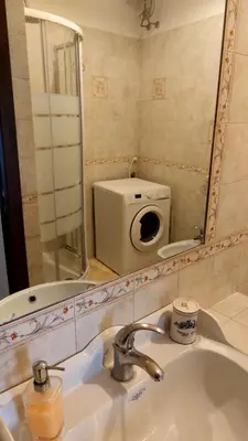 a bathroom with a sink and a mirror and a toilet at David house alla Vucciria in Palermo