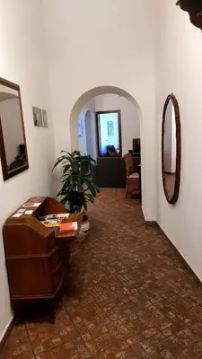 a living room with a table and a mirror at David house alla Vucciria in Palermo
