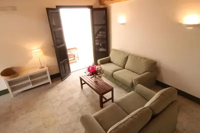 a living room with a couch and a table at Antico Baglio Siciliano in Balestrate