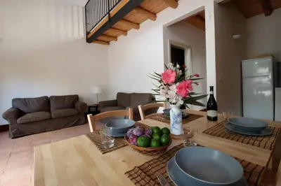 a living room with a table with a vase of flowers at Antico Baglio Siciliano in Balestrate