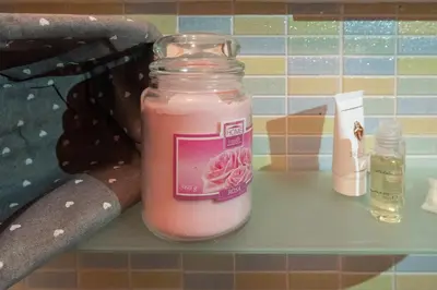 a jar of pink liquid sitting on a shelf at Nuovo Cortile Palermo Bed and Breakfast in Palermo