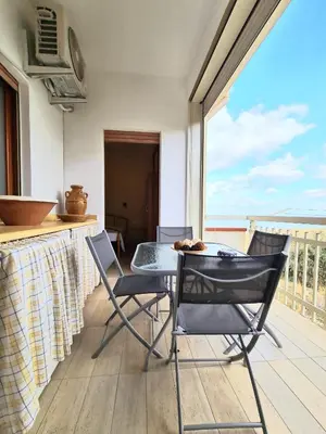 a table and chairs on a balcony with a view of the ocean at Casa Vacanze Sea-Life in Alcamo Marina