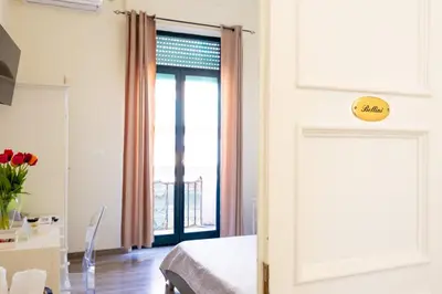 a bedroom with a bed and a large window at Il Sonaglio in Palermo