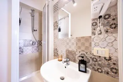a bathroom with a sink and a shower at Il Sonaglio in Palermo
