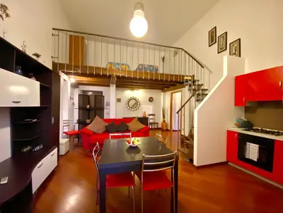 a living room with a red couch and a table at Elegante appartamento in centro in Palermo