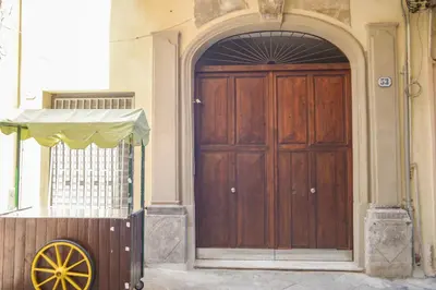 an entrance to a building with a wooden door at Marilù in Palermo