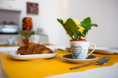 a table with a plate of bread and a cup of coffee at Darrè in Palermo
