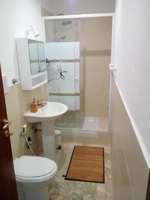a bathroom with a toilet and a sink and a shower at Darrè in Palermo