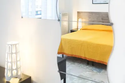 a bedroom with a bed with a yellow bedspread at Darrè in Palermo
