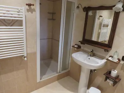 a bathroom with a sink and a shower with a mirror at Casale Giulietta in Scopello