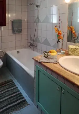 a bathroom with a tub and a sink at Villa Mediterranea in Scopello