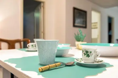 a table with cups and saucers on it at Guest House Antichi Ulivi in Mondello