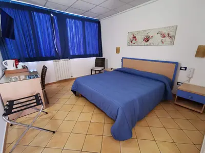 a bedroom with a blue bed and blue curtains at Al Baglio in Mondello
