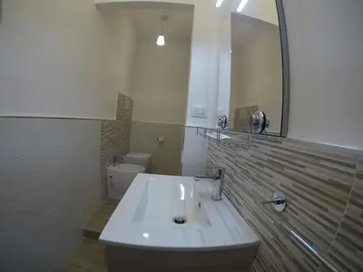 a bathroom with a sink and a mirror at I Vicini della Cattedrale in Palermo