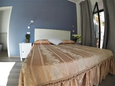 a bedroom with a bed with a brown bedspread at I Vicini della Cattedrale in Palermo
