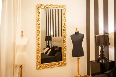 a mirror on a wall with two mannequins and a mannequin at BB 22 Charming Rooms & Apartments in Palermo