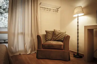 a living room with a chair and a lamp at BB 22 Charming Rooms & Apartments in Palermo