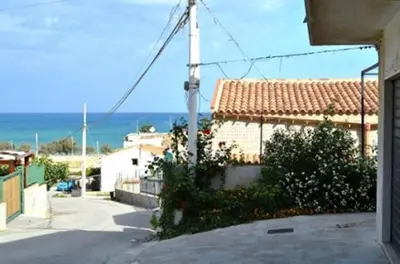 a view of a house with the ocean in the background at Casa Rachele ad Alcamo Marina in Alcamo Marina