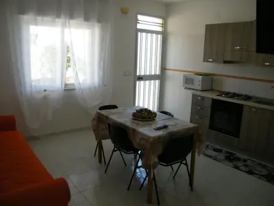 a kitchen with a table with a bowl of fruit on it at Casa Rachele ad Alcamo Marina in Alcamo Marina