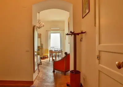 a hallway with a door leading to a dining room at Amazing Sea View in Historic Building in Downtown by Wonderful Italy in Palermo