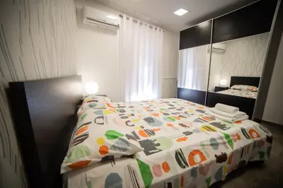 a bedroom with a bed and a large mirror at Casa degli Artisti San Lorenzo in Mezzojuso