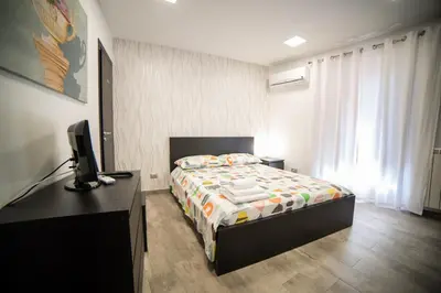 a bedroom with a bed and a desk with a television at Casa degli Artisti San Lorenzo in Mezzojuso