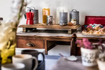 a table with food on it with a plate of food at Ad Hoc Rooms in Palermo