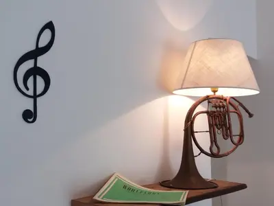 a lamp sitting on a table with a book and a treethinyl at Ad Hoc Rooms in Palermo