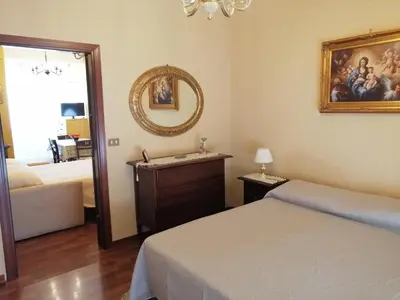 a bedroom with a bed and a mirror and a sink at Oreto Bridge in Palermo