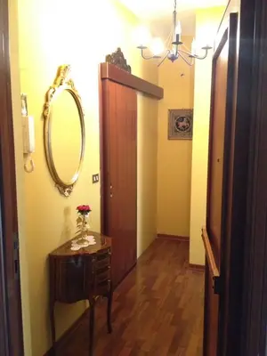 a hallway with a mirror and a table with a drawer at Oreto Bridge in Palermo
