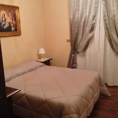 a bedroom with a bed and a window at Oreto Bridge in Palermo