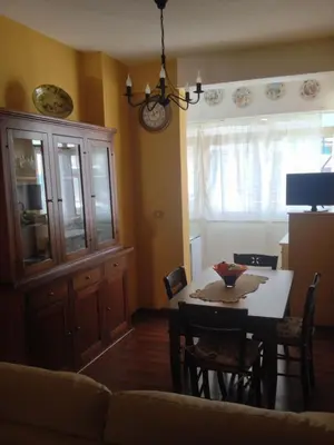 a living room with a table and a dining room at Oreto Bridge in Palermo
